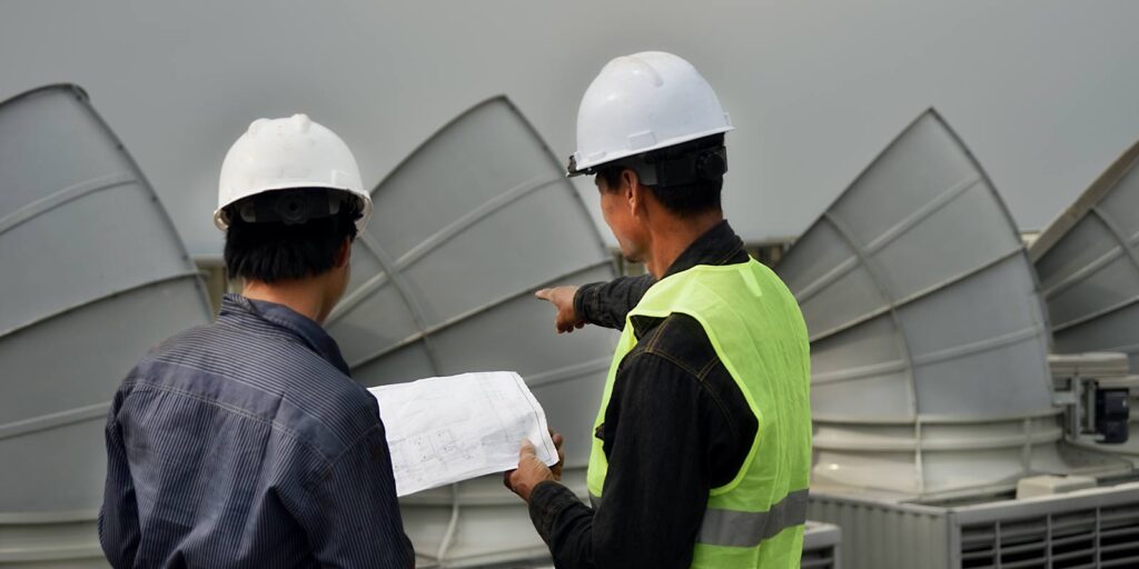 lcs-worker-explaining-corrective-action-to-properly-maintain-cooling-tower