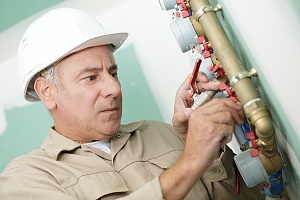 man working on a glycol cooling system's pipes