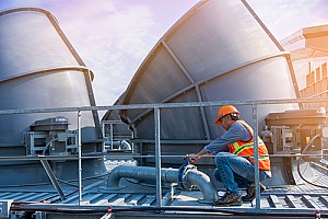 man servicing cooling tower