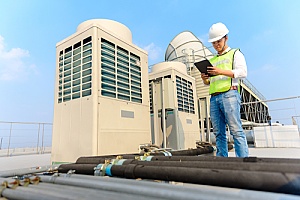 an employee of a Legionella testing company working on a cooling tower