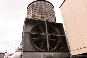 cooling tower in front of wooden water tower