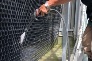worker cleaning cooling tower knowing Legionella Laws For Cooling Towers