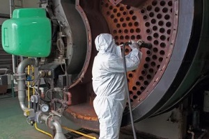 man cleaning gas boiler