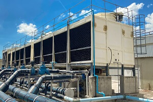 cooling tower is located in a large data center building installed on the roof on a bright blue sky