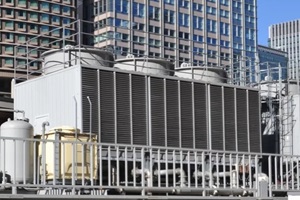 cooling tower for HVAC system with coils and fins on display with backdrop on city buildings