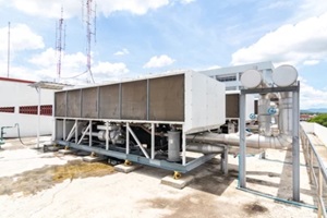 cooling tower setup on building top with mobile towers