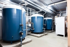 apartment building boiler room interior with modern water and space heating system