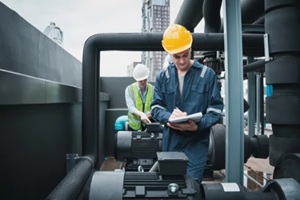 engineer and team examining the air conditioning cooling system of a huge building or industrial site